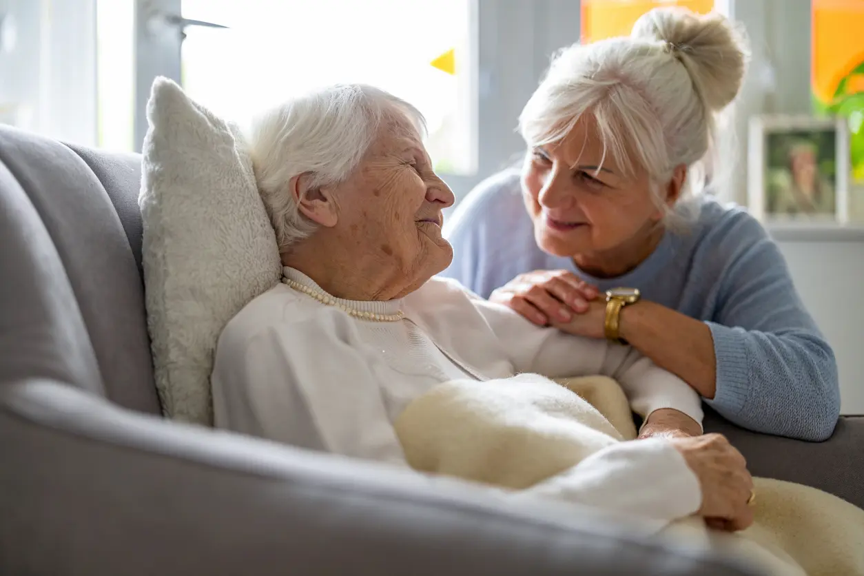 Caregiver and elderly person reviewing a clear profile together